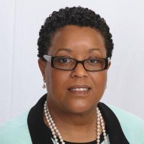 Woman wearing glasses and pearl necklace against white background
