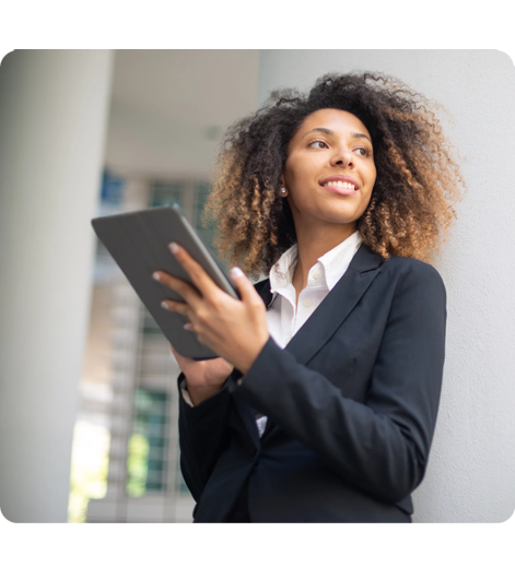 Professional woman in business attire holding tablet, modern office setting.